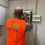 Installer installing an Inverter